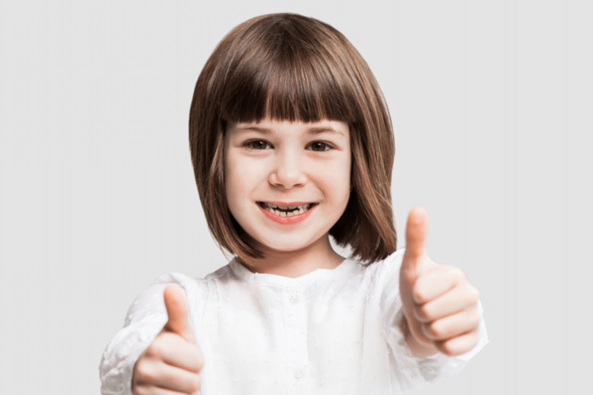 Young child with a missing baby tooth smiling for a pediatric dental blog in Humble TX